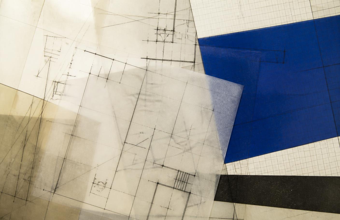 Overlapping translucent technical drawings and grid paper with a single deep blue panel, arranged as an abstract composition